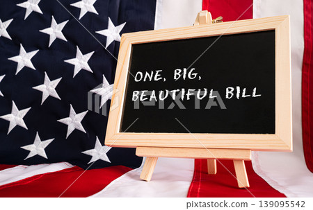 One Big Beautiful Bill Act chalkboard sign with American flag background, USA legislation budget concept One Big Beautiful Bill Act chalkboard sign with American flag background, USA legislation budget concept 139095542