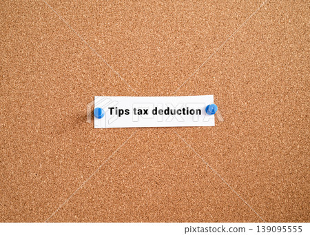 Tips tax deduction label note pinned on cork bulletin board. USA gratuity income tax policy finance concept Tips tax deduction label note pinned on cork bulletin board. USA gratuity income tax policy finance concept 139095555