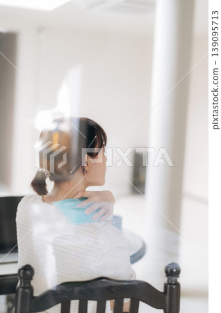 Focused asian woman sitting quietly at home studying online business using modern technology working hard to achieve success while looking thoughtful and calm in bright white spacious room Focused asian woman sitting quietly at home studying online business using modern technology working hard to achieve success while looking thoughtful and calm in bright white spacious room 139095713