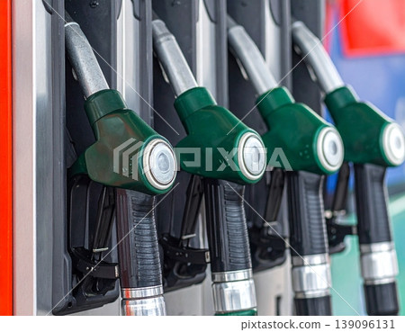 Fuel nozzles line up in a petrol station dispenser 139096131