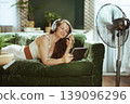 Blissful Woman Immersed in Audio and Tablet at Home 139096296