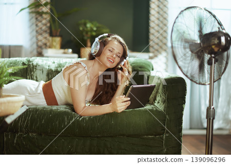 Blissful Woman Immersed in Audio and Tablet at Home 139096296