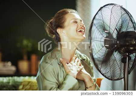 Peaceful Woman Cooling Down with Fan Peaceful Woman Cooling Down with Fan 139096303
