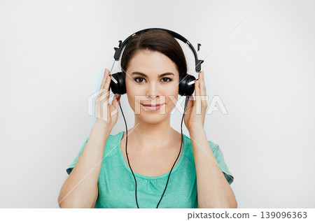 Audiometry, hearing exam. Mixed-race woman wearing special headphones getting a hearing diagnostic. Check-up your hear 139096363
