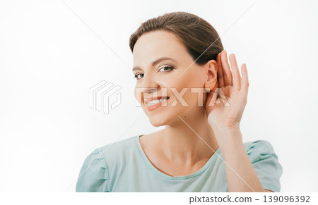 Check your hearing. Positive caucasian woman holds hand near ear, isolated on white background. Ear health, treatment, and diagnosis of hearing 139096392