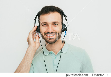 Hearing test, hearing diagnostic. A man wearing headphones having an audiometry test isolated in white 139096405