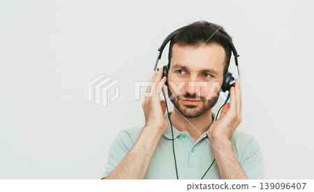 Mixed race man getting a hearing test, audiometer hearing test. On grey background 139096407
