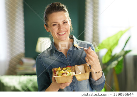 Woman with Healthy Fruit Snack in Sustainable Packaging Woman with Healthy Fruit Snack in Sustainable Packaging 139096644