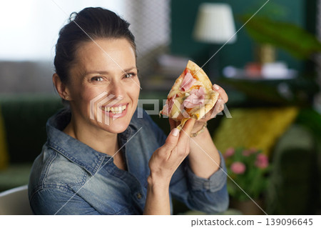 Happy Woman Holding a Slice of Ham Pizza Happy Woman Holding a Slice of Ham Pizza 139096645