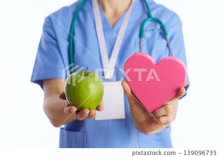 Doctor Holding Heart and Apple Symbolizing Preventive Care 139096735