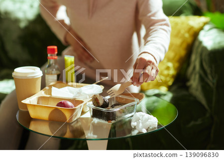 Convenience Dining at Home - Woman Eating Takeout Sushi 139096830