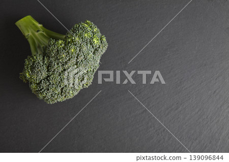 Organic Broccoli on Gray Granite Table. Green Broccoli on Dark Stone Surface Minimal Style. Organic Broccoli on Gray Granite Table. Green Broccoli on Dark Stone Surface Minimal Style. 139096844