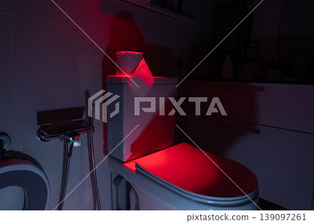 Toilet bowl with toilet paper roll in bathroom. Illumination for bowel movement problem concept. Toilet bowl with toilet paper roll in bathroom. Illumination for bowel movement problem concept. 139097261