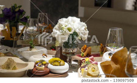 Luxury restaurant charcuterie board with artisan cheeses, cured meats, dates and edible flowers served at elegant Mediterranean dinner Luxury restaurant charcuterie board with artisan cheeses, cured meats, dates and edible flowers served at elegant Mediterranean dinner 139097509
