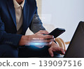 Business people are booking airline tickets online via virtual smartphones. 139097516