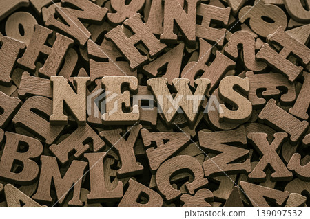 Inscription news on pile of old vintage wooden letters. Inscription news on pile of old vintage wooden letters. 139097532