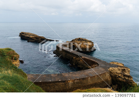 Scenic coastal view in Biarritz, France, featuring rocky formations and the ocean. Scenic coastal view in Biarritz, France, featuring rocky formations and the ocean. 139097781