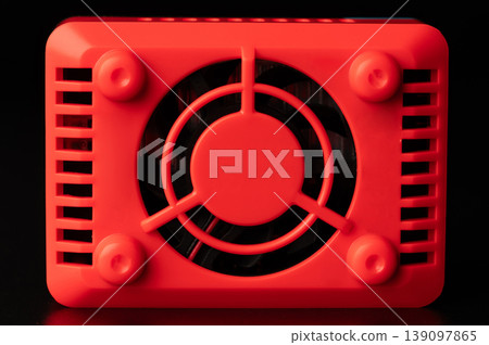 Red cooling fan on a black surface in a simple setup 139097865
