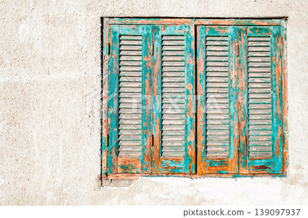window in wall with old wooden shutters window in wall with old wooden shutters 139097937