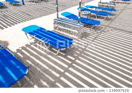 blue deck chairs under a canopy on the beach 139097938