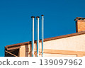 metal chimneys on the roof of the house 139097962