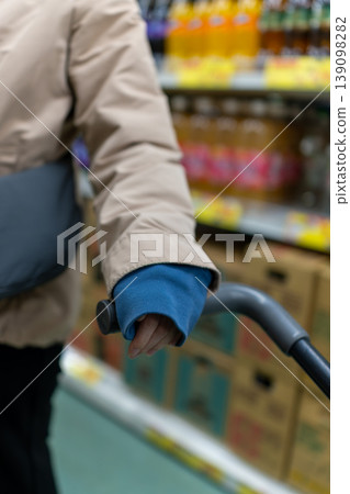 Shopping at the supermarket: Hands operating the shopping cart 139098282