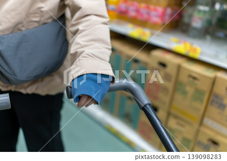Shopping at the supermarket: Hands operating the shopping cart 139098283