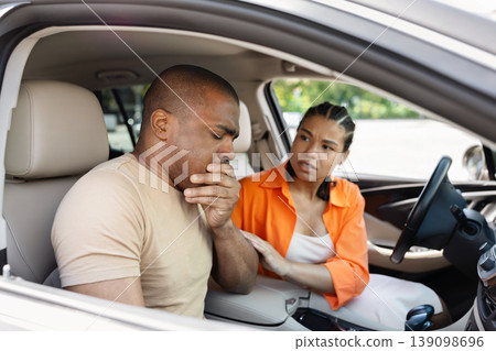 Young Black man feeling carsick, covering mouth with hand in car 139098696
