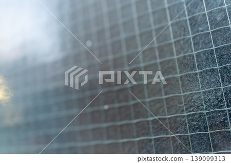 Abstract texture background with a bluish tint and wired glass. Abstract texture background with a bluish tint and wired glass. 139099313