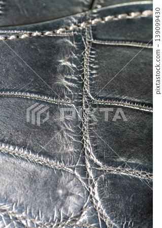A luxurious black crocodile leather texture background. A luxurious black crocodile leather texture background. 139099430