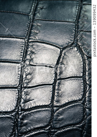 A luxurious black crocodile leather texture background. A luxurious black crocodile leather texture background. 139099432