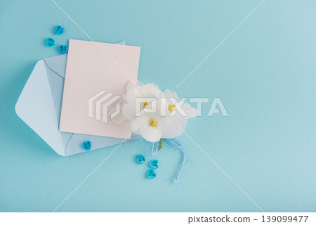 Blue Envelope with White Flowers and Card on Blue Background 139099477