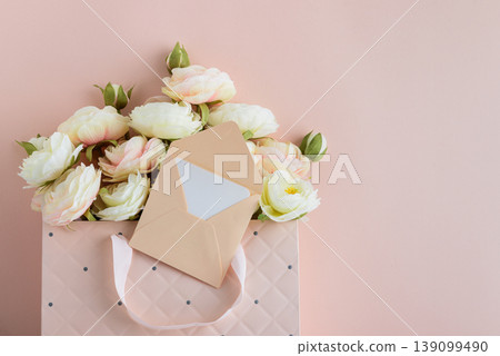 Pink Gift Bag with Flowers and Card on Pink Background 139099490