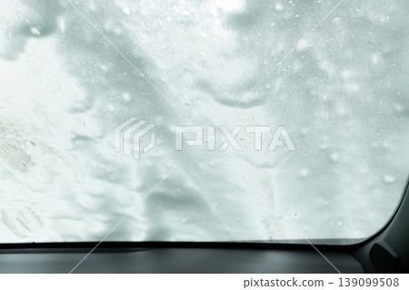 An abstract background of foam and a windshield as seen from inside a car wash. 139099508