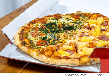 A mouthwatering close-up of a freshly baked pizza loaded with toppings. A mouthwatering close-up of a freshly baked pizza loaded with toppings. 139099556