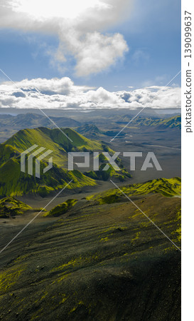 Aerial View of Moss Covered Mountains and Black Sand Plains in Iceland Aerial View of Moss Covered Mountains and Black Sand Plains in Iceland 139099637