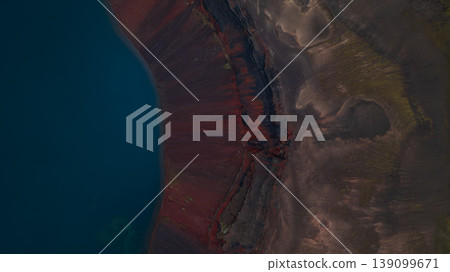 Aerial View of Volcanic Landscape and Deep Blue Water in Iceland 139099671