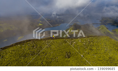 Aerial View of Hikers on Moss Covered Ridge in Iceland's Volcanic Landscape Aerial View of Hikers on Moss Covered Ridge in Iceland's Volcanic Landscape 139099685