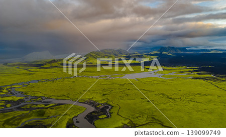 Aerial View of Iceland's Moss Covered Plains and Volcanic Mountains 139099749