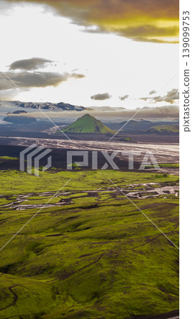 Aerial View of Moss Covered Terrain and Cone Shaped Mountain in Iceland Aerial View of Moss Covered Terrain and Cone Shaped Mountain in Iceland 139099753