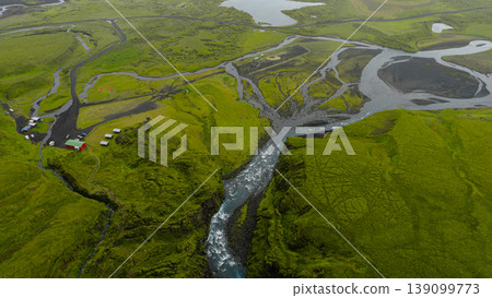 Aerial View of Icelandic River, Waterfall, and Red Roofed Building Aerial View of Icelandic River, Waterfall, and Red Roofed Building 139099773