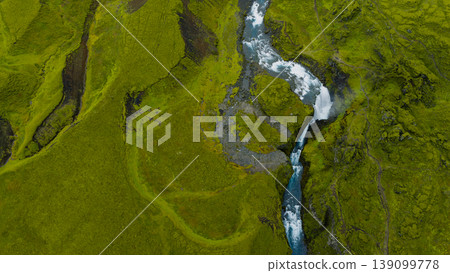 Aerial View of Icelandic Waterfall Amid Rugged Volcanic Landscape Aerial View of Icelandic Waterfall Amid Rugged Volcanic Landscape 139099778