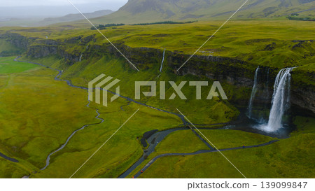 Seljalandsfoss Waterfall with Lush Green Fields and Walking Paths 139099847