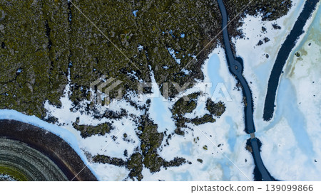 Aerial View of Iceland's Snowy Terrain and Volcanic Rock Formations 139099866