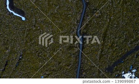 Aerial View of Winding Road Through Moss Covered Volcanic Terrain in Iceland Aerial View of Winding Road Through Moss Covered Volcanic Terrain in Iceland 139099867