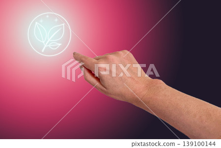 Hand pointing to natural leaf neon icon on pink gradient background for eco skincare, organic beauty product, sustainable cosmetics, wellness care and natural spa treatment. 139100144