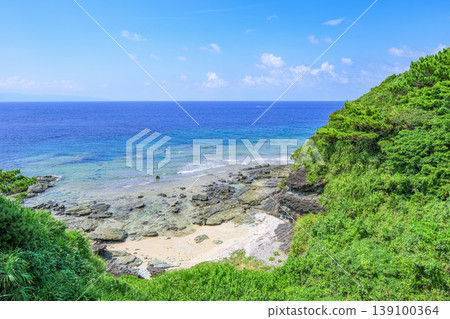 A beautiful summer scene of Ishigaki Island, with a lush green cove and the blue sea. A beautiful summer scene of Ishigaki Island, with a lush green cove and the blue sea. 139100364
