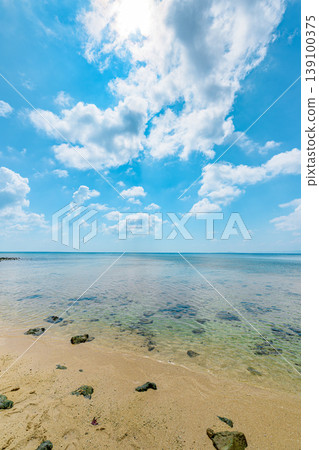 The tranquil seaside scenery of Osaki Beach in Ishigaki Island, with its shallow waters and beautiful blue sky. The tranquil seaside scenery of Osaki Beach in Ishigaki Island, with its shallow waters and beautiful blue sky. 139100375