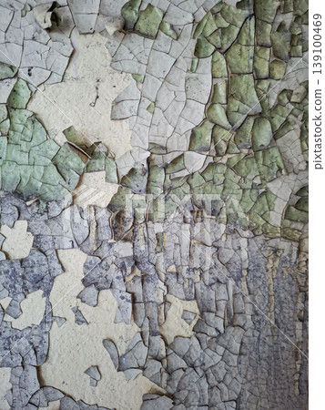 Cracked and peeling layers of paint cover the walls in a historic factory, revealing the effects of time and neglect. The colors blend and reveal the history of the building. Cracked and peeling layers of paint cover the walls in a historic factory, revealing the effects of time and neglect. The colors blend and reveal the history of the building. 139100469