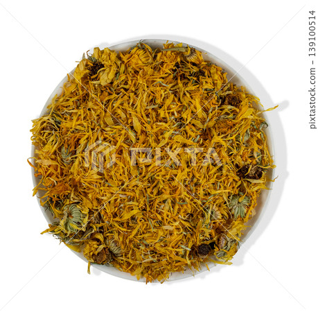 A white bowl sits isolated with dried calendula petals and flower heads. This simple setup highlights the natural color and texture of the dried herbs, suitable for herbal remedies or tea preparation. A white bowl sits isolated with dried calendula petals and flower heads. This simple setup highlights the natural color and texture of the dried herbs, suitable for herbal remedies or tea preparation. 139100514